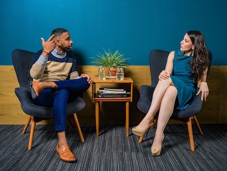 A man and woman engaging in conversation.